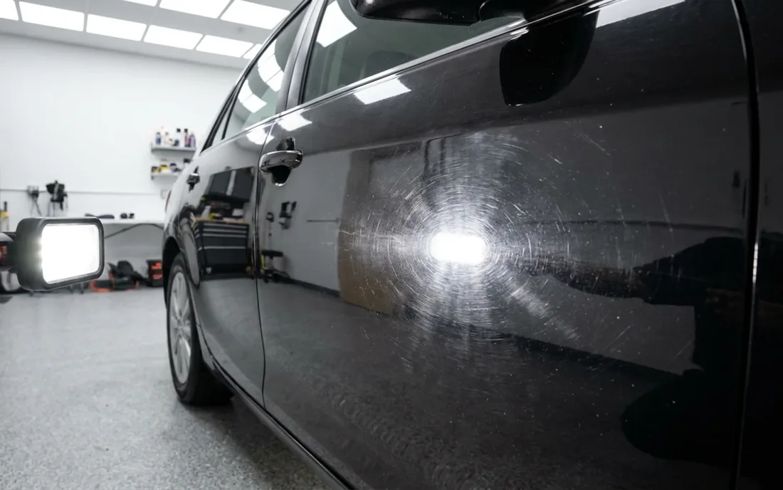 Car paint with heavy swirl marks and scratches before correction