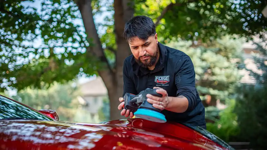 1 Step paint correction — machine polishing a red car by Forge Auto Studio in Denver