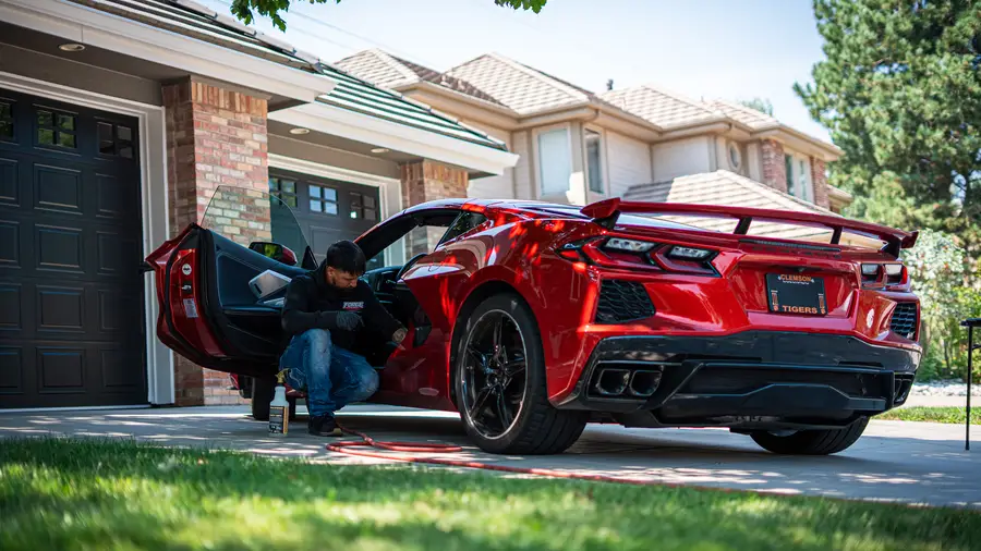 Forge Auto Studio exterior detailing a red Corvette in a Denver driveway